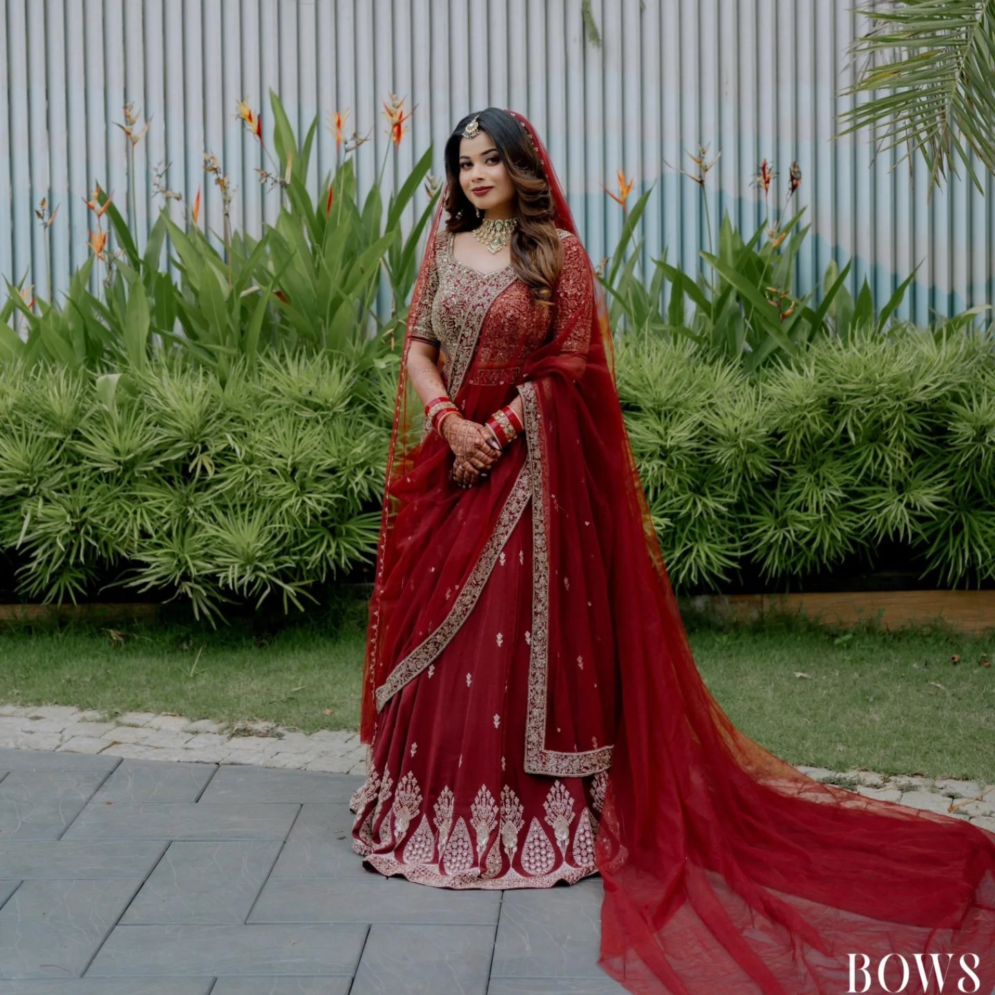 Bride in deep red Kanchipuram silk saree with gold zari border